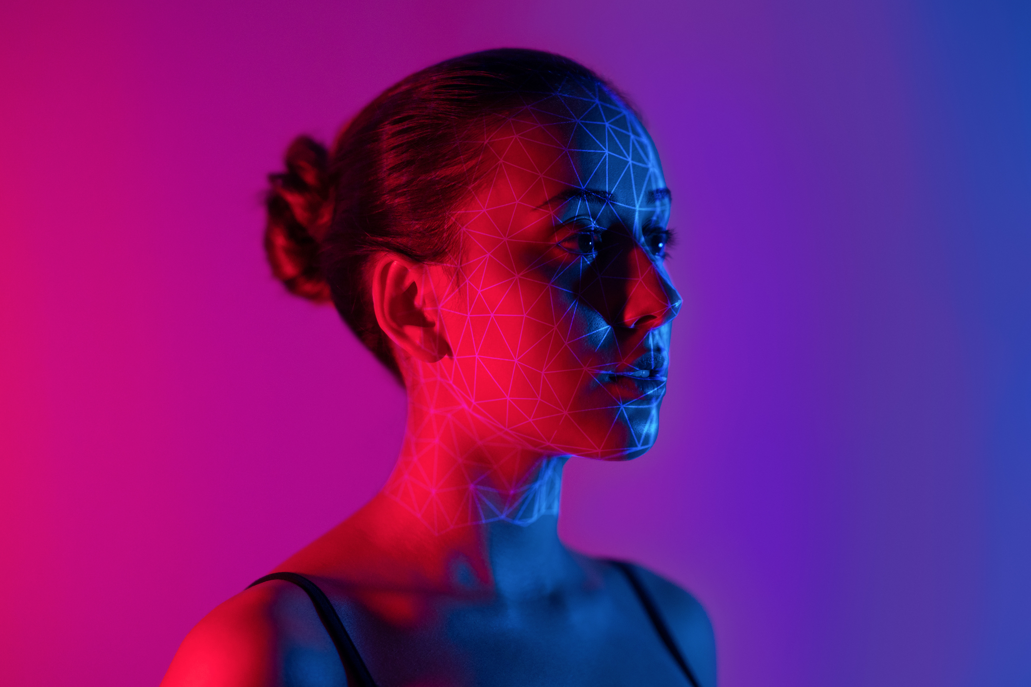 Young female model with 3d mesh outlines overlapping her face.