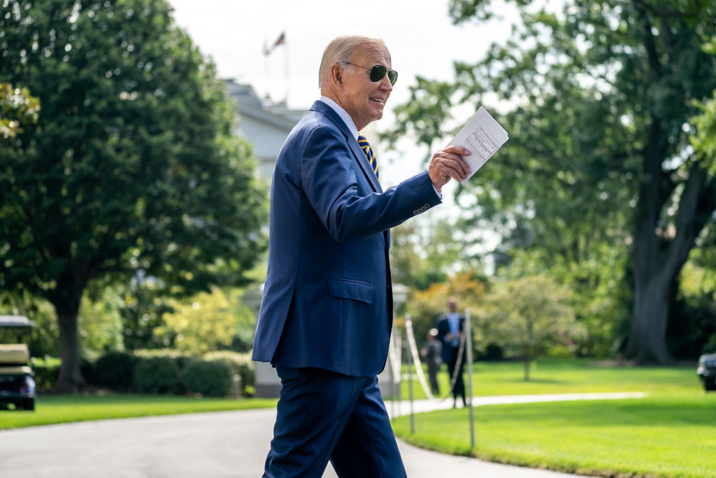 US President Joe Biden walks on the South Lawn of the White House before boarding Marine One in Washington, DC, on Aug. 15, 2023. Biden is leading an administration-wide effort to mark the one-year anniversary of the Democrats landmark climate and drug pricing legislation whose implementation officials are counting on to fuel the presidents reelection bid.