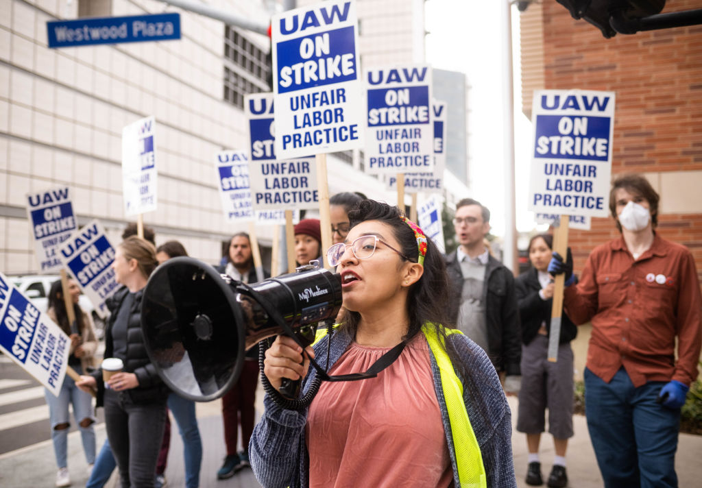 Gloria Bartolo, a 2nd year molecular biology PhD student, leads UCLA postdoctoral scholars and academic researchers on a strike through Westwood, Los Angeles, as they demand better wages, student housing, and child care from the University of California on December 1, 2022.