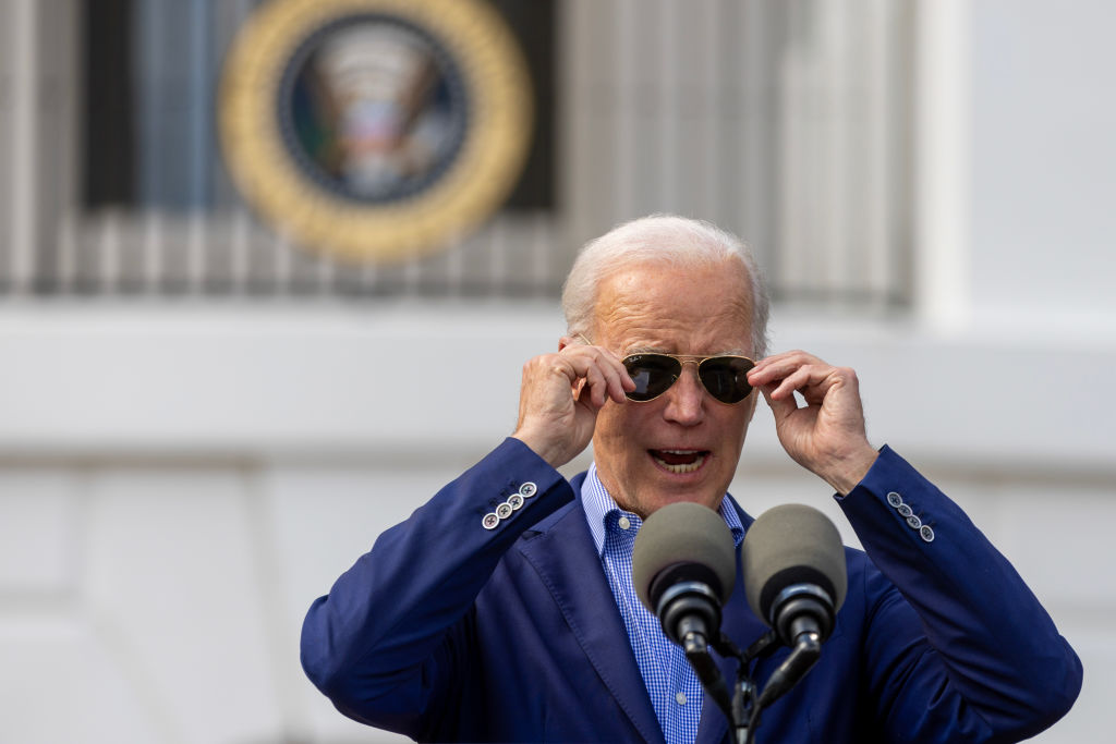 President Biden adjusting his sunglasses