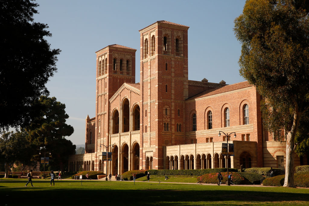 Students walk past Royce Hall on the University of California Los Angeles (UCLA) campus.