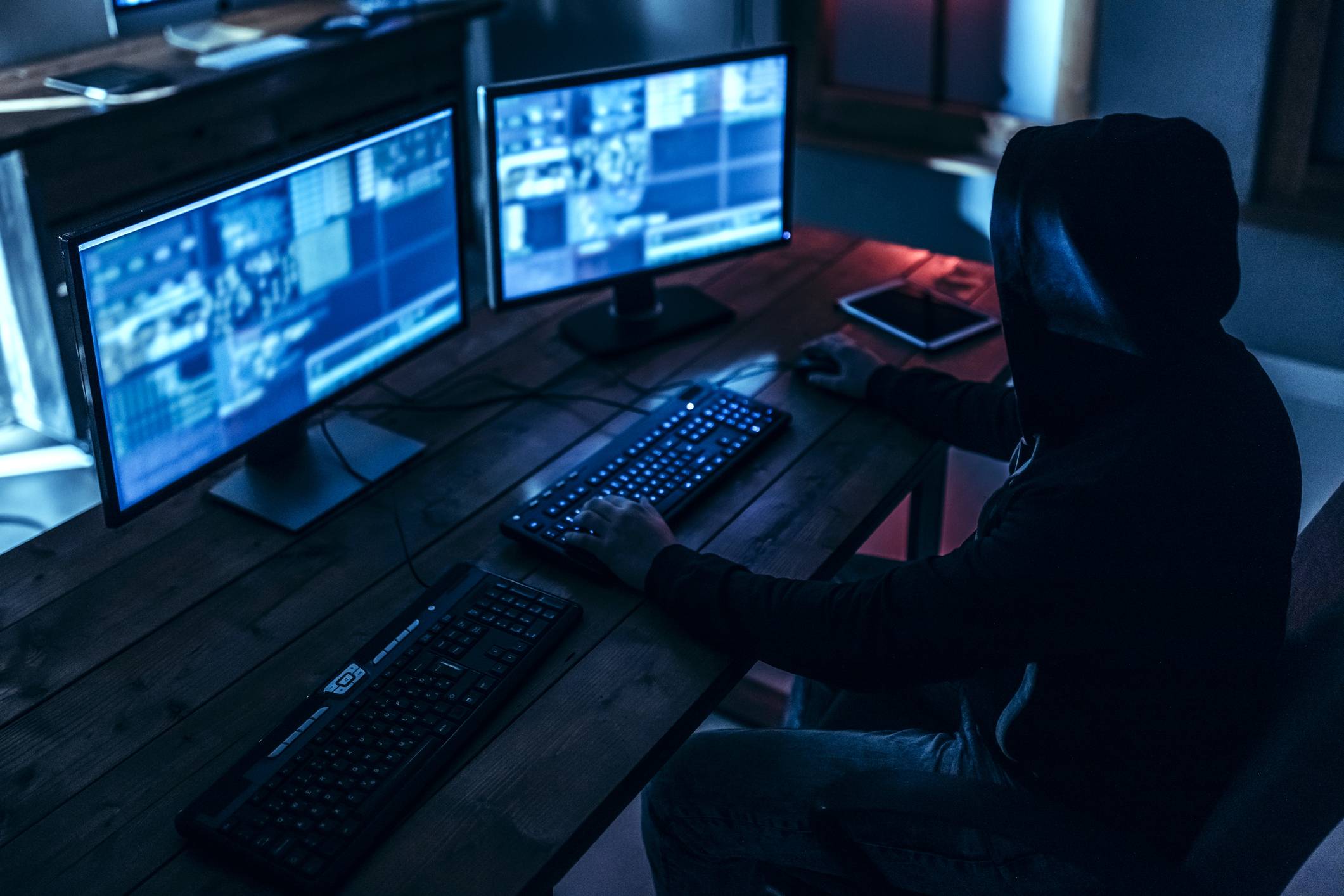 Person looking at surveillance cameras on computer monitors