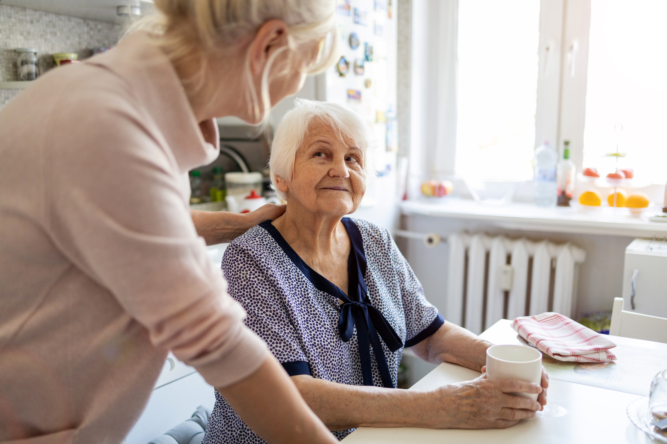 Adult daughter caring for her elderly mother with dementia