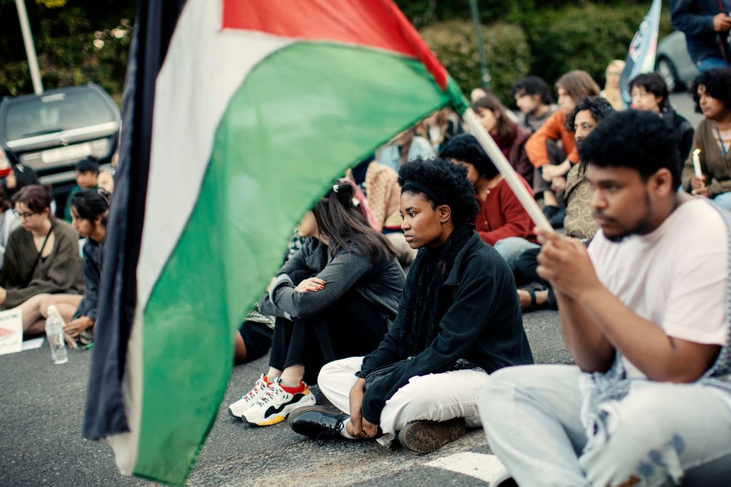 Activists and pro-Palestinian participants attend a vigil organized by a group of Jewish, Muslim, and Christian students to protest the Israel-Hamas conflict.