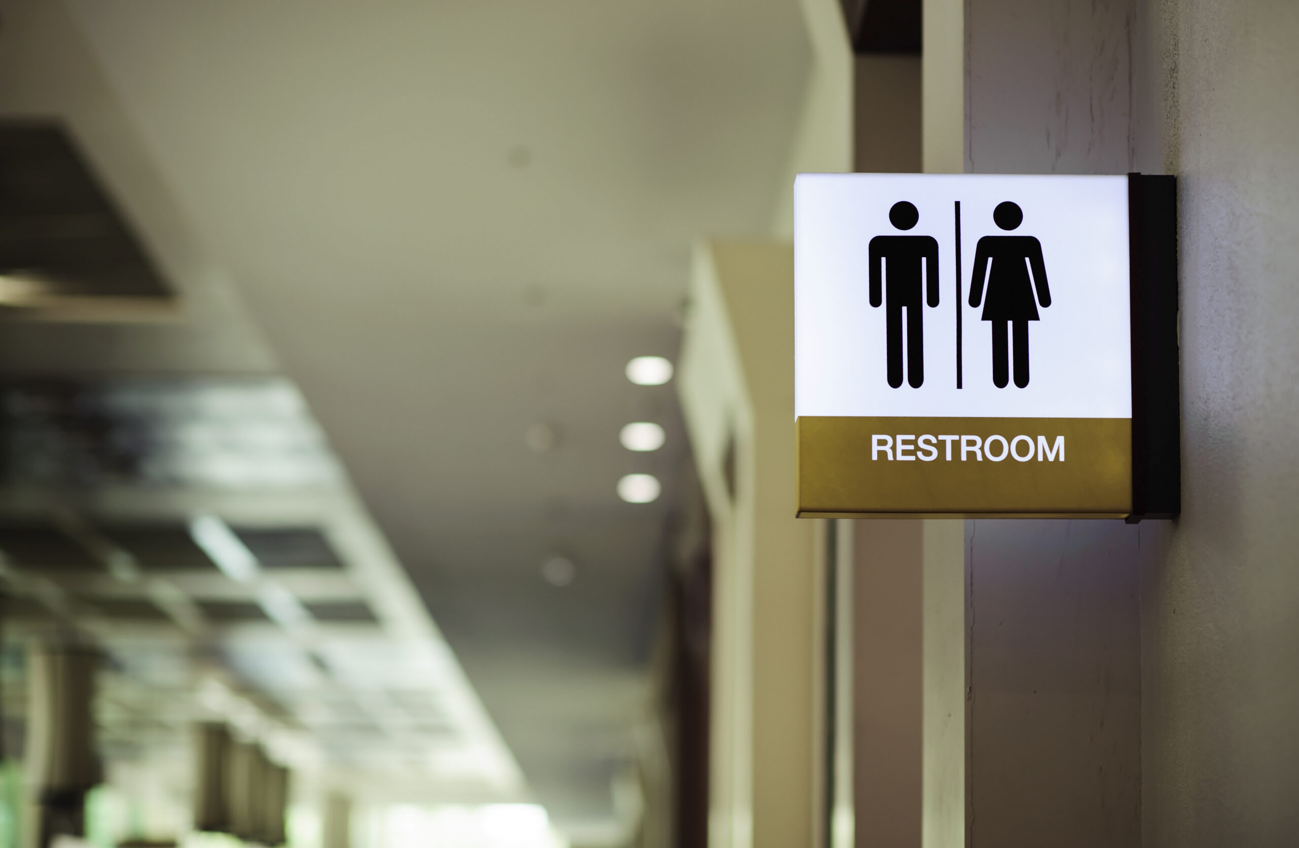 Sign at the entrance of a public restroom in a school building.