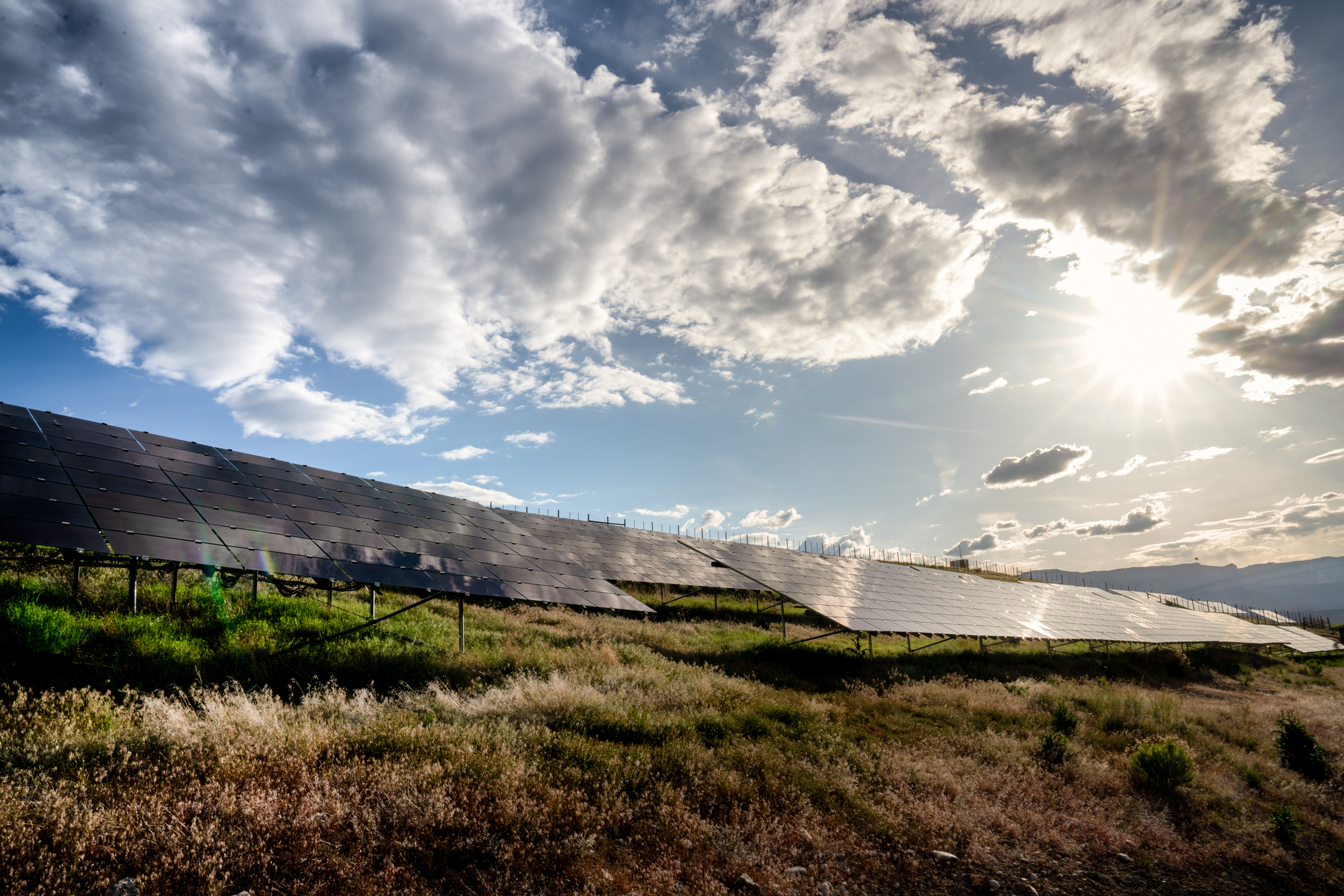 A beautiful blue sky and cloudscape around sunset at a solar farm in Western Colorado.