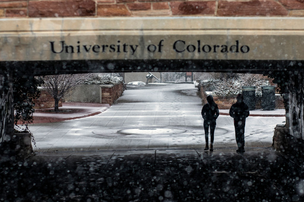 Students walk through the University of Colorado Boulder campus during a winter storm in Boulder, Colorado, on March 13, 2021.