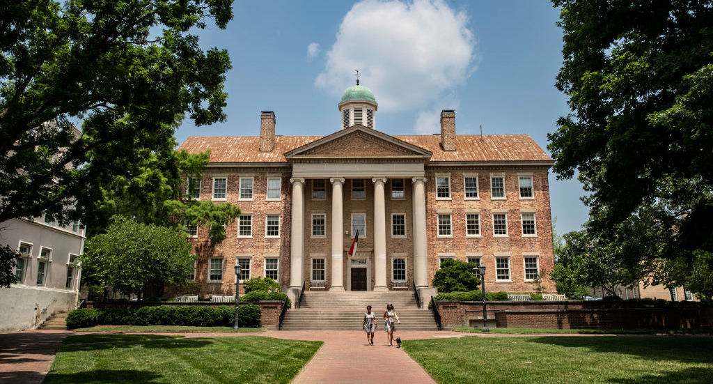 People walk on the campus of the University of North Carolina Chapel Hill on June 29, 2023.